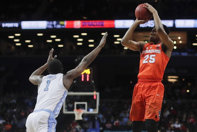Syracuse guard Tyus Battle (25) shoots over North Carolina forward Theo Pinson (1) during the first half of an NCAA college basketball game in the second round of the Atlantic Coast Conference men's tournament Wednesday, March 7, 2018, in New York. (AP Photo/Julie Jacobson)