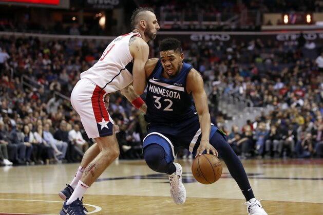 Minnesota Timberwolves center Karl-Anthony Towns (32) drives against Washington Wizards center Marcin Gortat (13), from Poland, during the first half of an NBA basketball game, Tuesday, March 13, 2018, in Washington. (AP Photo/Alex Brandon) Minnesota Timberwolves center Karl-Anthony Towns (32) drives against Washington Wizards center Marcin Gortat (13), from Poland, during the first half of an NBA basketball game, Tuesday, March 13, 2018, in Washington. (AP Photo/Alex Brandon)