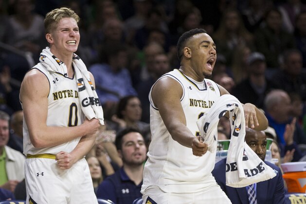 Notre Dame's Rex Pflueger (0) and Bonzie Colson (35) celebrate from the bench during the second half of an NCAA college basketball game Wednesday, Feb. 28, 2018, in South Bend, Ind. Notre Dame won 73-56. (AP Photo/Robert Franklin)