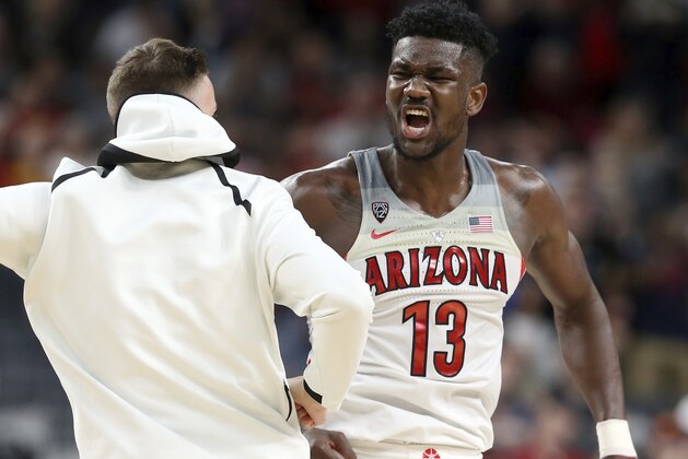 Arizona's Deandre Ayton, right, celebrates an overtime win with a teammate following the team's NCAA college basketball game against UCLA in the semifinals of the Pac-12 men's tournament Friday, March 9, 2018, in Las Vegas. Arizona won 78-67. (AP Photo/Isaac Brekken)