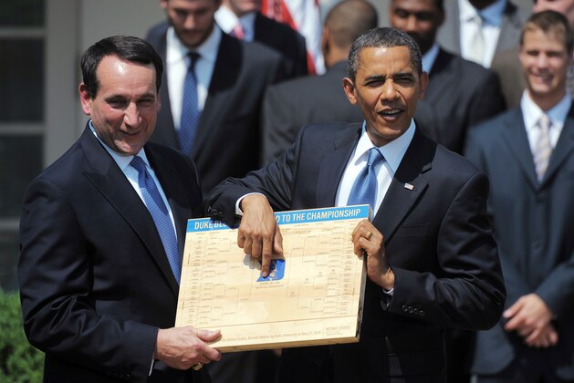 The Blue Devils head coach Mike Krzyzewski presents US President Barack Obama(R) with a copy of the NCAA bracket during an event in honour of the NCAA Menï¿½s Basketball Champion Duke Blue Devils May 27, 2010 in the Rose Garden of the White House in Washington, DC. AFP PHOTO/Mandel NGAN (Photo credit should read MANDEL NGAN/AFP/Getty Images)