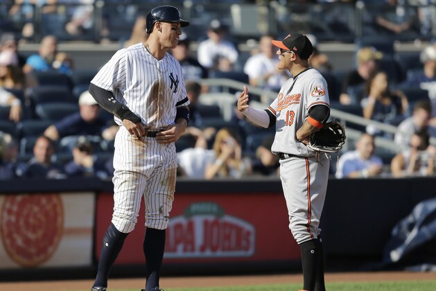 New York Yankees' Aaron Judge, left, talks with Baltimore Orioles third baseman Manny Machado during the eighth inning of a baseball game at Yankee Stadium, Sunday, Sept. 17, 2017, in New York. (AP Photo/Seth Wenig)