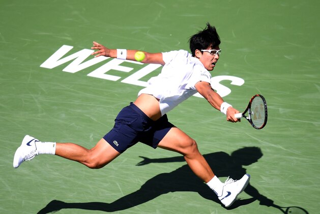 INDIAN WELLS, CA - MARCH 14:  Hyeon Chung of South Korea streches to his a backhand in his match against Pablo Cuevas of Uruguay during the BNP Paribas Open at the Indian Wells Tennis Garden on March 14, 2018 in Indian Wells, California.  (Photo by Harry How/Getty Images)