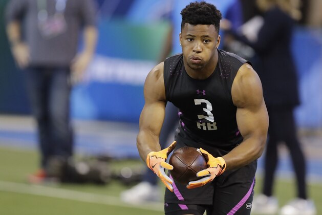 Penn State running back Saquon Barkley runs a drill during the NFL football scouting combine, Friday, March 2, 2018, in Indianapolis. (AP Photo/Darron Cummings)