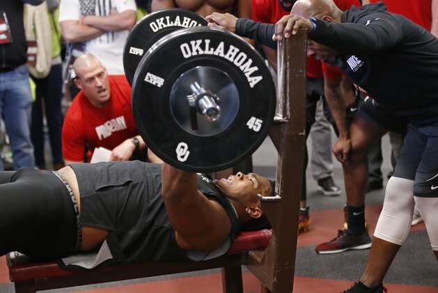 Oklahoma offensive lineman Orlando Brown lifts weights during an NCAA college football Pro Day workout in Norman, Okla., Wednesday, March 14, 2018. Brown had a historically bad NFL Scouting Combine and is trying to improve his falling draft stock at Oklahoma's Pro Day. (AP Photo/Sue Ogrocki)
