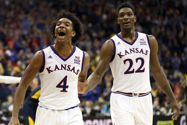 KANSAS CITY, MO - MARCH 10:  Devonte' Graham #4 of the Kansas Jayhawks celebrates with Silvio De Sousa #22 after the Jayhawks defeated the West Virginia Mountaineers 81-70 to win the Big 12 Basketball Tournament Championship game at Sprint Center on March 10, 2018 in Kansas City, Missouri.  (Photo by Jamie Squire/Getty Images)