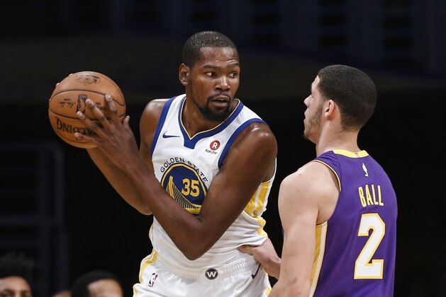 Golden State Warriors forward Kevin Durant, left, is defended by Los Angeles Lakers guard Lonzo Ball during the first half of an NBA basketball game Wednesday, Nov. 29, 2017, in Los Angeles. (AP Photo/Ringo H.W. Chiu)