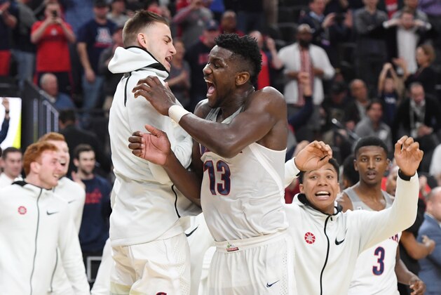 LAS VEGAS, NV - MARCH 10:  Deandre Ayton (C) #13 of the Arizona Wildcats celebrates with teammates on the court after the team defeated the USC Trojans 75-61 to win the championship game of the Pac-12 basketball tournament at T-Mobile Arena on March 10, 2018 in Las Vegas, Nevada.  (Photo by Ethan Miller/Getty Images)