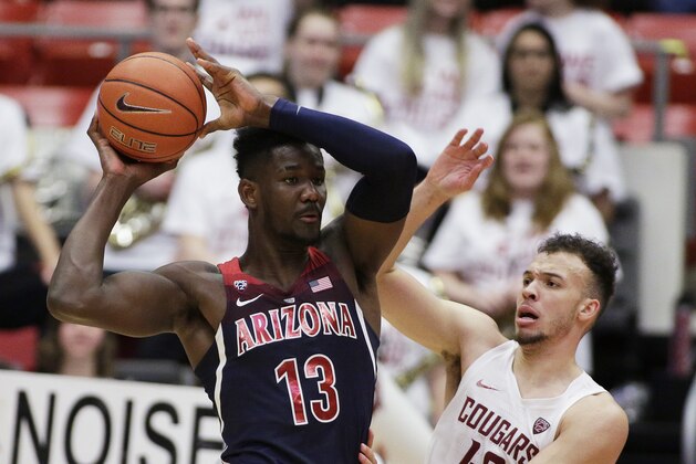 Arizona forward Deandre Ayton (13) prepares to pass the ball while defended by Washington State forward Drick Bernstine (43) during the second half of an NCAA college basketball game in Pullman, Wash., Wednesday, Jan. 31, 2018. (AP Photo/Young Kwak)