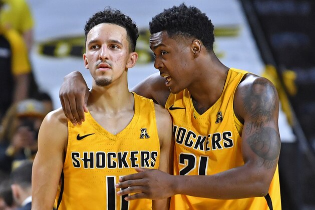 WICHITA, KS - MARCH 04:  Landry Shamet #11 of the Wichita State Shockers talks with teammate Darral Willis Jr. #21 as they walk up court during the second half against the Cincinnati Bearcats on March 4, 2018 at Charles Koch Arena in Wichita, Kansas.  (Photo by Peter G. Aiken/Getty Images)