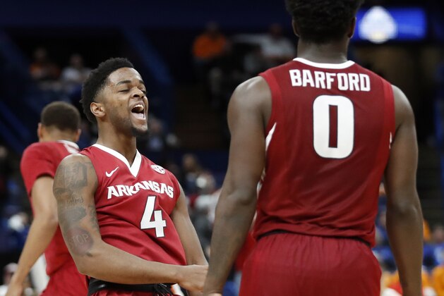 Arkansas' Daryl Macon, left, and Jaylen Barford celebrate during the second half of an NCAA college basketball quarterfinal game against Florida at the Southeastern Conference tournament Friday, March 9, 2018, in St. Louis. Arkansas won 80-72. (AP Photo/Jeff Roberson)