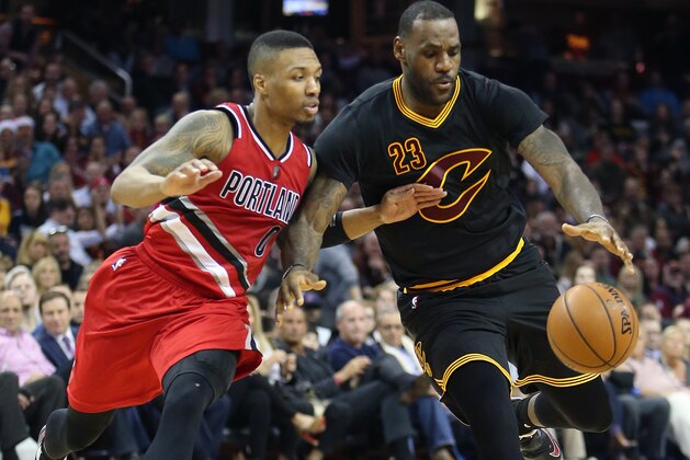 Cleveland Cavaliers forward LeBron James (23) drives on Portland Trail Blazers guard Damian Lillard (0) during the second half of an NBA basketball game Tuesday, Dec. 8, 2015, in Cleveland. The Cavaliers won 105-100. (AP Photo/Ron Schwane)