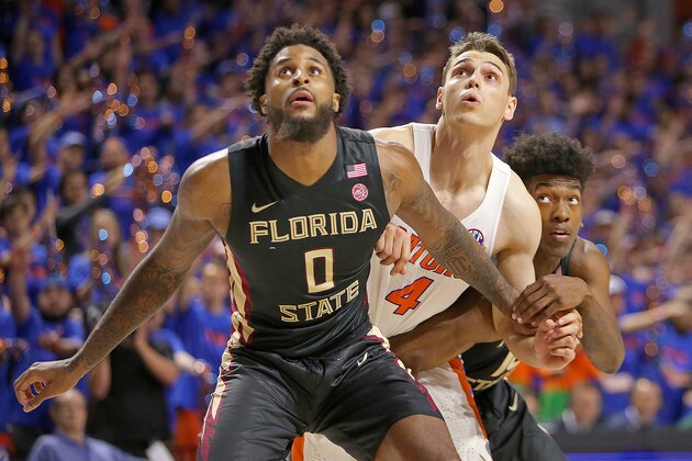 GAINESVILLE, FL - DECEMBER 04:  Phil Cofer #0 and Terance Mann #14 of the Florida State Seminoles block out Egor Koulechov #4 of the Florida Gators during a NCAA basketball game at the Stephen C. O' Connell Center on December 4, 2017 in Gainesville, Florida. (Photo by Alex Menendez/Getty Images)
