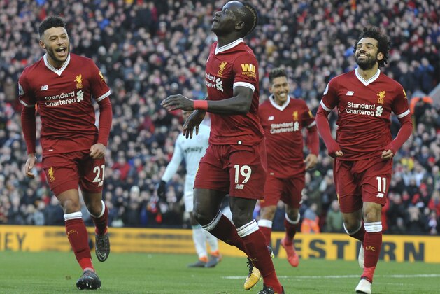 Liverpool's Sadio Mane, centre, celebrates scoring his sides fourth goal during the English Premier League soccer match between Liverpool and West Ham United at Anfield in Liverpool, England, Saturday, Feb. 24, 2018. (AP Photo/Rui Vieira)
