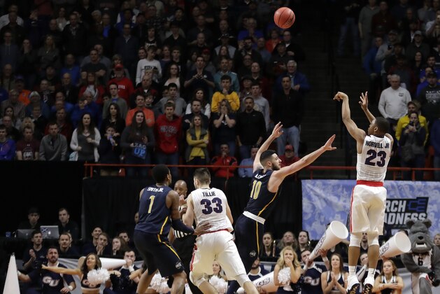 Gonzaga guard Zach Norvell Jr. (23) sinks a 3-point tie-breaking shot over UNC-Greensboro guard Francis Alonso (10) in the final minute of the second half of an NCAA college basketball tournament first-round game, Thursday, March 15, 2018, in Boise, Idaho. Gonzaga won 68-64. (AP Photo/Ted S. Warren)