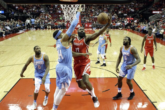 Houston Rockets' James Harden (13) goes up for a shot as LA Clippers' Tobias Harris (34) defends during the first half of an NBA basketball game Thursday, March 15, 2018, in Houston. (AP Photo/David J. Phillip)