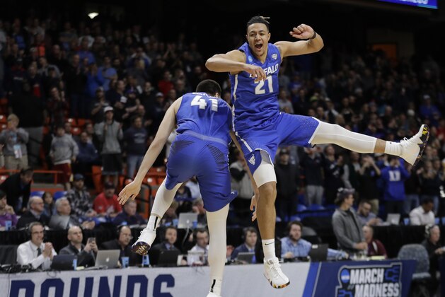 Buffalo's Dominic Johnson, right, and Brock Bertram celebrate after Buffalo upset Arizona 89-68 in first-round game in the NCAA men's college basketball tournament Thursday, March 15, 2018, in Boise, Idaho. (AP Photo/Ted S. Warren)