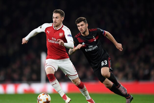 LONDON, ENGLAND - MARCH 15:  Aaron Ramsey of Arsenal breaks from Patrick Cutrone of AC Milan during the UEFA Europa League Round of 16 Second Leg match between Arsenal and AC Milan at Emirates Stadium on March 15, 2018 in London, England.  (Photo by Shaun Botterill/Getty Images)