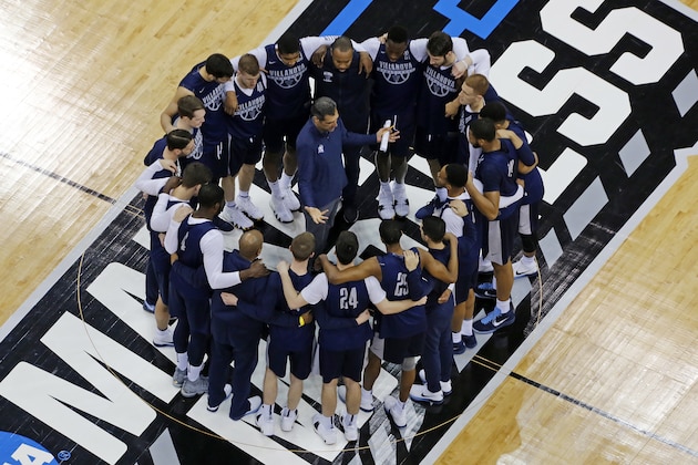 Villanova head coach Jay Wright, center, huddles his team at center court after a practice for an NCAA college basketball first round game at PPG Paints Arena in Pittsburgh Wednesday, March 14, 2018. AP Photo/Gene J. Puskar)