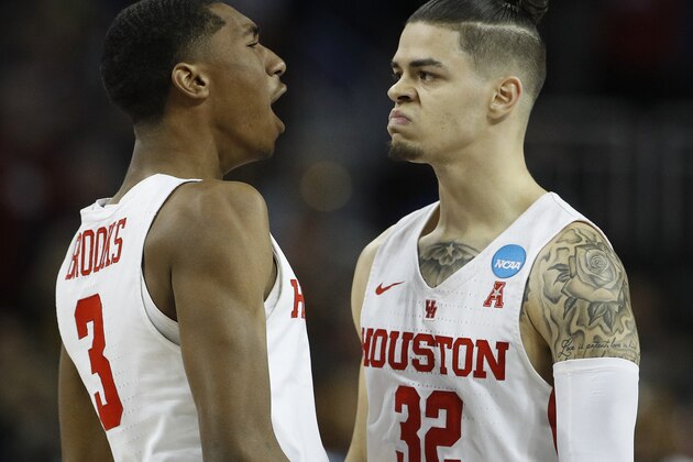 Houston guard Rob Gray, right,  celebrates with teammate Armoni Brooks, left, after making the game-winning basket in a NCAA men's college basketball tournament first-round game against San Diego State Thursday, March 15, 2018, in Wichita, Kan. Houston won 67-65. (AP Photo/Charlie Riedel)