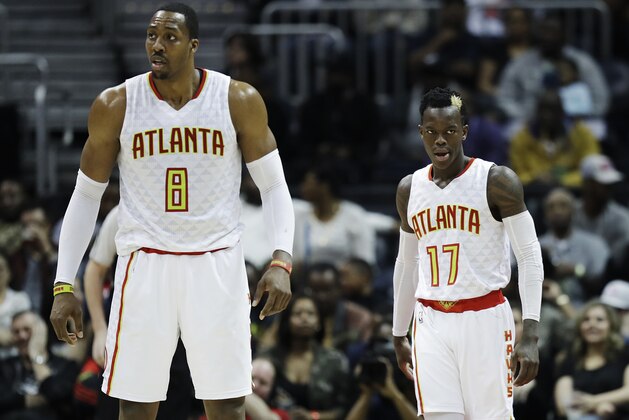 Atlanta Hawks' Dennis Schroder, right of Germany, and teammate Dwight Howard stand on the court in the fourth quarter of an NBA basketball game against the Brooklyn Nets in Atlanta, Wednesday, March 8, 2017. (AP Photo/David Goldman)