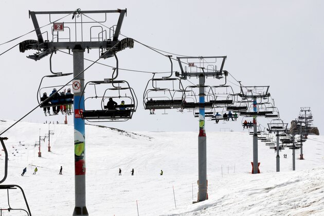 People sit on a chair lift in the Lebanese ski resort of Faraya, north of Beirut, on March 4, 2018. / AFP PHOTO / ANWAR AMRO        (Photo credit should read ANWAR AMRO/AFP/Getty Images)