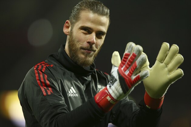 Manchester United goalkeeper David de Gea applauds the fans as he takes part in the warm up prior to the start of the Champions League round of 16 second leg soccer match between Manchester United and Sevilla, at Old Trafford in Manchester, England, Tuesday, March 13, 2018. (AP Photo/Dave Thompson)