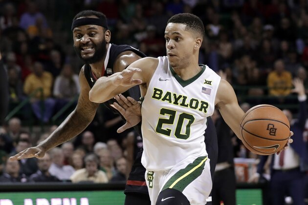 Baylor's Manu Lecomte (20), of Belgium, gets past Texas Tech forward Tommy Hamilton IV (0) for a shot-attempt in the second half of an NCAA college basketball game Saturday, Feb. 17, 2018, in Waco, Texas. (AP Photo/Tony Gutierrez)