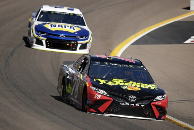 Monster Energy NASCAR Cup Series driver Martin Truex Jr. (78) leads Chase Elliott on the 25th lap during a NASCAR Cup Series auto race on Sunday, March 11, 2018, in Avondale, Ariz. (AP Photo/Rick Scuteri)