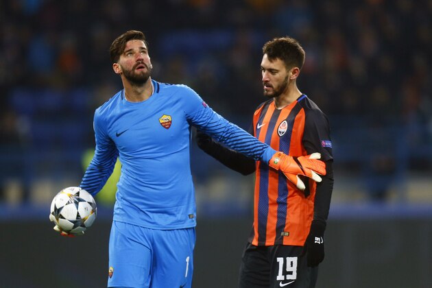 Roma goalkeeper Alisson Becker, left, discusses with Shakhtar's Facundo Ferreyra during the Champions League, round of 16, first-leg soccer match between Shakhtar Donetsk and Roma at the Metalist Stadium in Kharkiv, Ukraine, Wednesday, Feb. 21, 2018. (AP Photo/Efrem Lukatsky)