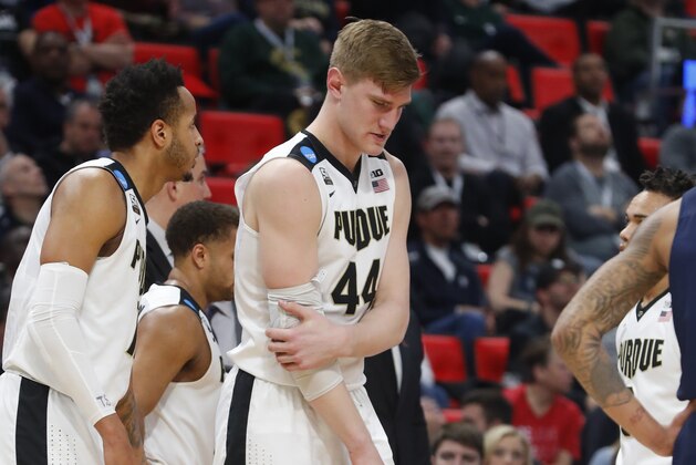 Purdue center Isaac Haas (44) holds his right elbow against Cal State Fullerton during the second half of an NCAA men's college basketball tournament first-round game in Detroit, Friday, March 16, 2018. Haas broke his right elbow in Purdue's 74-48 victory on Friday and will miss the rest of the NCAA Tournament. (AP Photo/Paul Sancya)