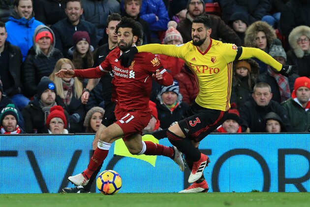 Liverpool's Egyptian midfielder Mohamed Salah (L) vies with Watford's Uruguayan defender Miguel Britos during the English Premier League football match between Liverpool and Watford at Anfield in Liverpool, north west England on March 17, 2018. / AFP PHOTO / Lindsey PARNABY / RESTRICTED TO EDITORIAL USE. No use with unauthorized audio, video, data, fixture lists, club/league logos or 'live' services. Online in-match use limited to 75 images, no video emulation. No use in betting, games or single club/league/player publications.  /         (Photo credit should read LINDSEY PARNABY/AFP/Getty Images)
