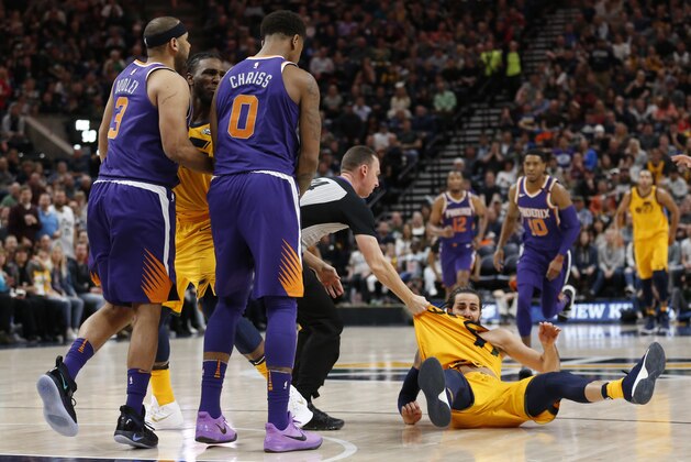 Phoenix Suns' Jared Dudley (3) and Marquese Chriss (0) stand nearby after shoving Utah Jazz's Ricky Rubio, right, to the court during the second of an NBA basketball game Thursday, March 15, 2018, in Salt Lake City. Dudley and Chriss were ejected with a flagrant 2 fouls. (AP Photo/Rick Bowmer)