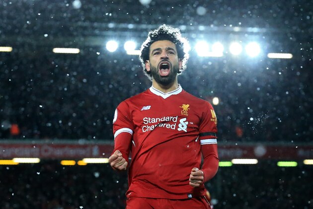 Liverpool's Egyptian midfielder Mohamed Salah celebrates scoring the fourth goal during the English Premier League football match between Liverpool and Watford at Anfield in Liverpool, north west England on March 17, 2018. / AFP PHOTO / Lindsey PARNABY / RESTRICTED TO EDITORIAL USE. No use with unauthorized audio, video, data, fixture lists, club/league logos or 'live' services. Online in-match use limited to 75 images, no video emulation. No use in betting, games or single club/league/player publications.  /         (Photo credit should read LINDSEY PARNABY/AFP/Getty Images)