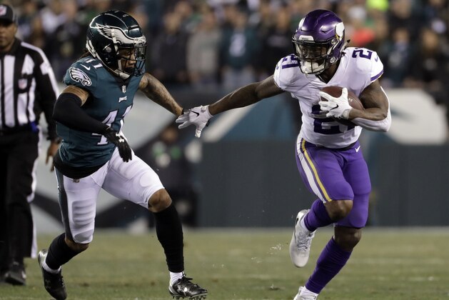 File-This Jan. 21, 2018, file photo shows Minnesota Vikings' Jerick McKinnon running past Philadelphia Eagles' Ronald Darby during the first half of the NFL football NFC championship game in Philadelphia. The 49ers agreed to a four-year contract with versatile running back McKinnon and a five-year deal with interior offensive lineman Weston Richburg on Wednesday, March 14, 2018 just after the start of the new league year. McKinnon will replace starter Carlos Hyde, who was allowed to leave in free agency.(AP Photo/Matt Slocum, File)