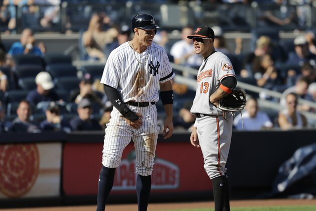New York Yankees' Aaron Judge, left, talks with Baltimore Orioles third baseman Manny Machado during the eighth inning of a baseball game at Yankee Stadium, Sunday, Sept. 17, 2017, in New York. (AP Photo/Seth Wenig)