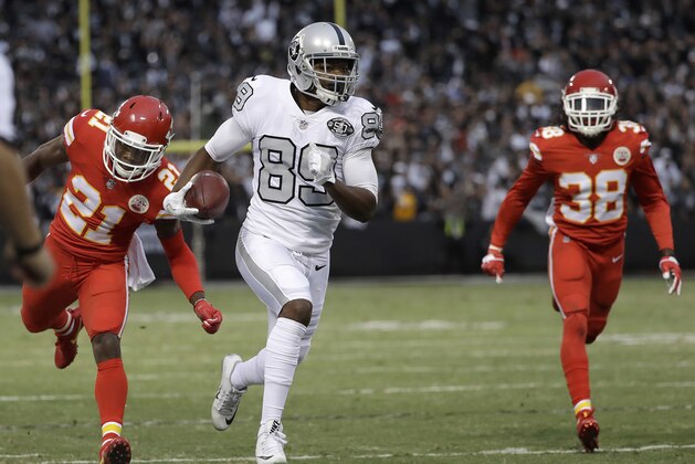 Oakland Raiders wide receiver Amari Cooper (89) runs past Kansas City Chiefs cornerback Eric Murray (21) and defensive back Ron Parker (38) to score a touchdown during the first half of an NFL football game in Oakland, Calif., Thursday, Oct. 19, 2017. (AP Photo/Marcio Jose Sanchez)