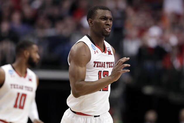 Texas Tech guard Keenan Evans (12) celebrates sinking a basket against Florida during the first half of a second-round game in the men's NCAA college basketball tournament in Dallas, Saturday, March 17, 2018. (AP Photo/Tony Gutierrez)