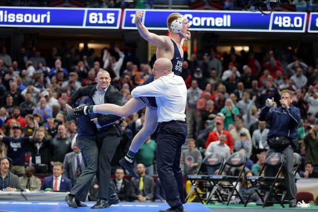 CLEVELAND, OH - MARCH 17: Bo Nickal of the Penn State Nittany Lions celebrates with head coach Cael Sanderson after winning the 184 pound championship match and clinching the team title during session six of the NCAA Wrestling Championships on March 17, 2018 at QuickenLoans Arena in Cleveland, Ohio. (Photo by Hunter Martin/Getty Images)