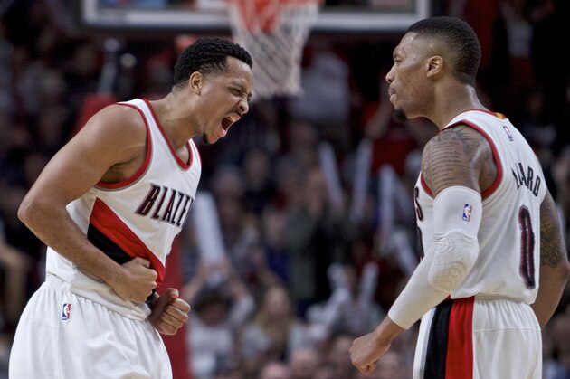 Portland Trail Blazers guard CJ McCollum, left, and guard Damian Lillard react after McCollum scored late in the second half of an NBA basketball game against the Milwaukee Bucks in Portland, Ore., Tuesday, March 21, 2017. The Bucks won 93-90. (AP Photo/Craig Mitchelldyer)