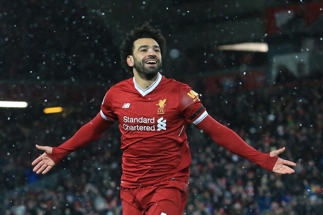 Liverpool's Egyptian midfielder Mohamed Salah celebrates scoring the team's fourth goal during the English Premier League football match between Liverpool and Watford at Anfield in Liverpool, north west England on March 17, 2018. / AFP PHOTO / Lindsey PARNABY / RESTRICTED TO EDITORIAL USE. No use with unauthorized audio, video, data, fixture lists, club/league logos or 'live' services. Online in-match use limited to 75 images, no video emulation. No use in betting, games or single club/league/player publications.  /         (Photo credit should read LINDSEY PARNABY/AFP/Getty Images)
