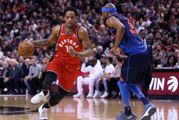 TORONTO, ON - MARCH 18:  DeMar DeRozan #10 of the Toronto Raptors dribbles the ball as Corey Brewer #3 of the Oklahoma City Thunder defends during the second half of an NBA game at Air Canada Centre on March 18, 2018 in Toronto, Canada.  NOTE TO USER: User expressly acknowledges and agrees that, by downloading and or using this photograph, User is consenting to the terms and conditions of the Getty Images License Agreement.  (Photo by Vaughn Ridley/Getty Images)