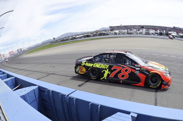 Race leader Martin Truex Jr. exits turn two during the NASCAR 400 mile auto race Sunday, March 18, 2018, at Auto Club Speedway in Fontana, Calif . (AP Photo/Will Lester)
