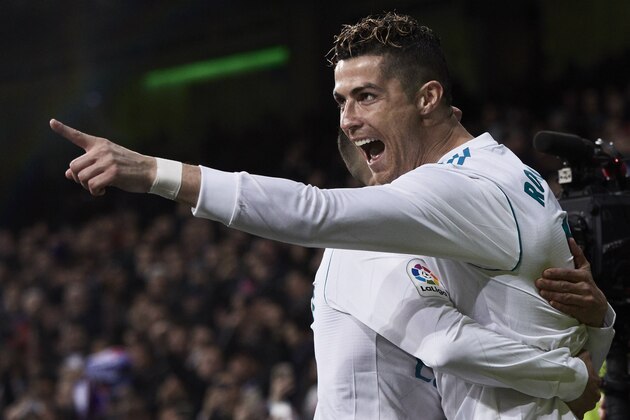 MADRID, SPAIN - MARCH 18: Cristiano Ronaldo (R) of Real Madrid CF celebrates scoring their second goal with teammate Lucas Vazquez (L)  during the La Liga match between Real Madrid CF and Girona FC at Estadio Santiago Bernabeu on March 18, 2018 in Madrid, Spain. (Photo by Gonzalo Arroyo Moreno/Getty Images)
