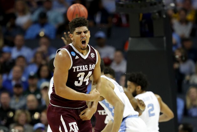 CHARLOTTE, NC - MARCH 18:  Tyler Davis #34 of the Texas A&M Aggies reacts after scoring against the North Carolina Tar Heels during the second round of the 2018 NCAA Men's Basketball Tournament at Spectrum Center on March 18, 2018 in Charlotte, North Carolina.  (Photo by Streeter Lecka/Getty Images)