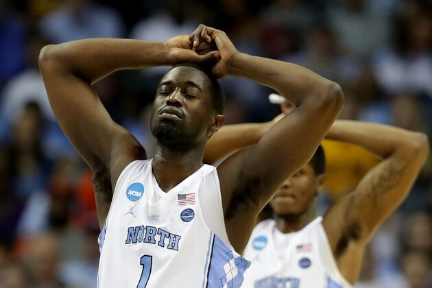 CHARLOTTE, NC - MARCH 18:  Theo Pinson #1 and teammate Kenny Williams #24 of the North Carolina Tar Heels react at the end of their game against the Texas A&M Aggies during the second round of the 2018 NCAA Men's Basketball Tournament at Spectrum Center on March 18, 2018 in Charlotte, North Carolina.  (Photo by Streeter Lecka/Getty Images)