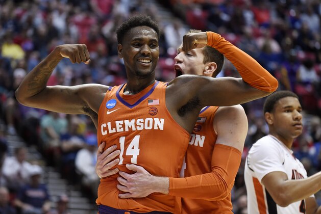 Clemson forward Elijah Thomas, front, celebrates a basket with forward David Skara during the first half of a second-round NCAA men's college basketball tournament game against Auburn on Sunday, March 18, 2018, in San Diego. (AP Photo/Denis Poroy)