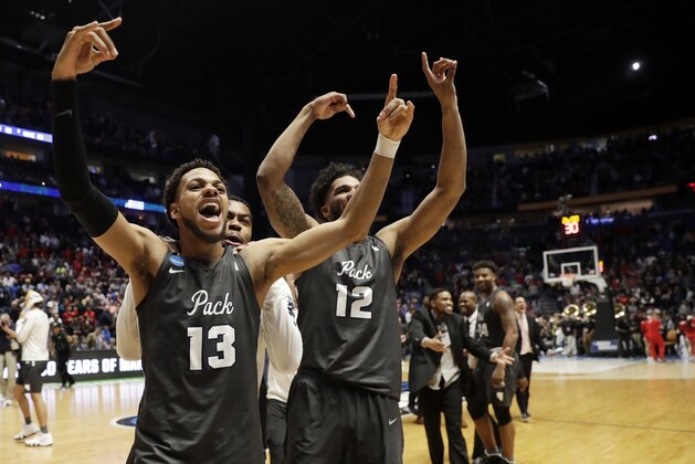 Nevada guard Hallice Cooke (13) and forward Elijah Foster (12) celebrate at the end end of the second half of a second-round game against Cincinnati, in the NCAA college basketball tournament in Nashville, Tenn., Sunday, March 18, 2018. Nevada defeated Cincinnati 75-73. (AP Photo/Mark Humphrey)