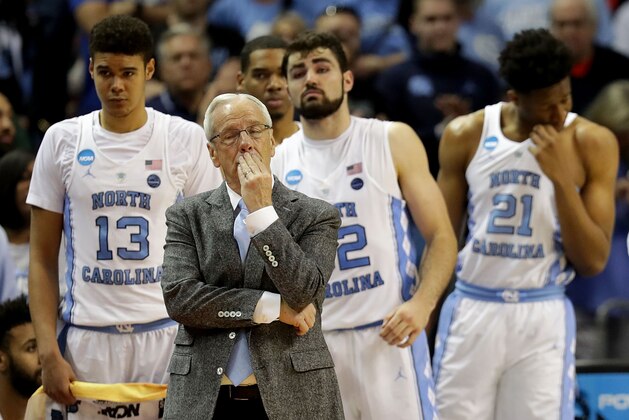 CHARLOTTE, NC - MARCH 18:  Head coach Roy Williams of the North Carolina Tar Heels and his team react to their 86-65 loss to the Texas A&M Aggies during the second round of the 2018 NCAA Men's Basketball Tournament at Spectrum Center on March 18, 2018 in Charlotte, North Carolina.  (Photo by Streeter Lecka/Getty Images)