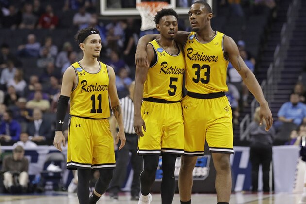 UMBC's Arkel Lamar, Jourdan Grant and K.J. Maura, from right, embrace as they leave the court in the closing moments of the team's 50-43 loss to Kansas State in a second-round game in the NCAA men's college basketball tournament in Charlotte, N.C., Sunday, March 18, 2018. (AP Photo/Gerry Broome)